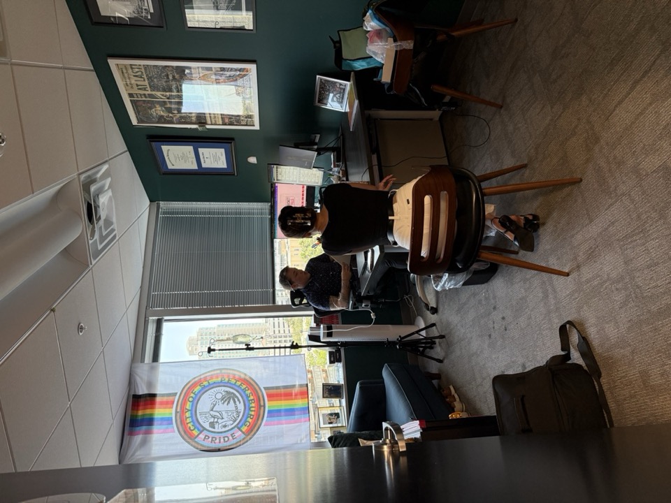 A busy professional receiving mobile IV therapy in her office before a travel day — Salty Fluids Immunity IV with energy support